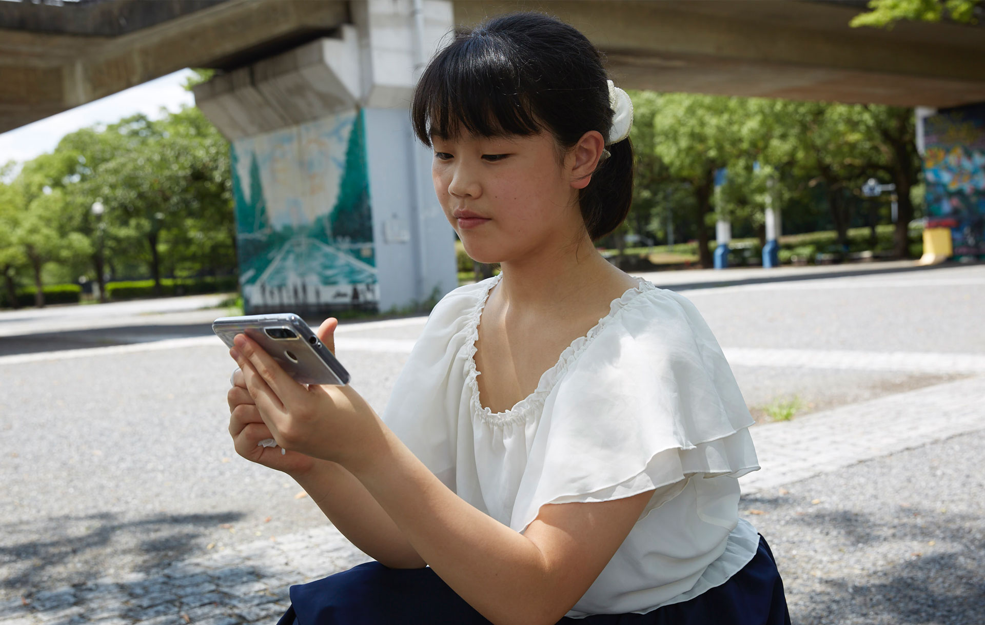 Lenovo New Realities Noi Tatsuzaki looking at smartphone