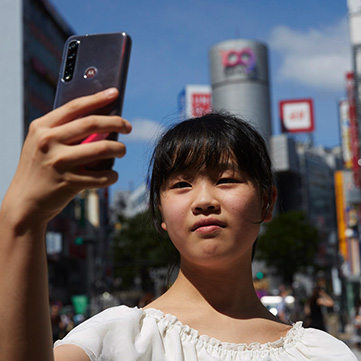 Lenovo New Realities Noi Tatsuzaki looking at phone