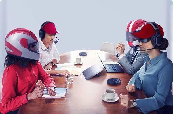A meeting with multiple people wearing F1 pit race equipment using the Lenovo ThinkSmart