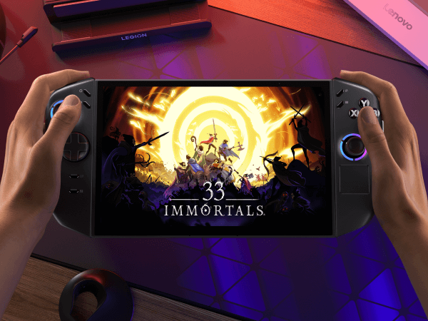 Two hands hold a Lenovo Legion Go Gen 2, which has the title screen of the game “33 Immortals” on its display.
