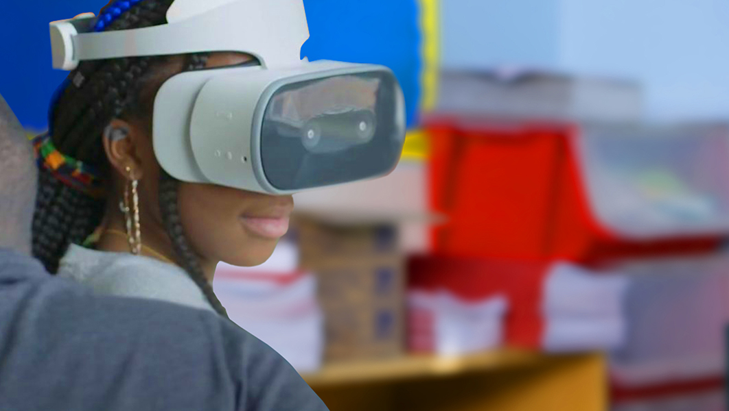 A young girl uses a Lenovo Mirage VR headset in a classroom