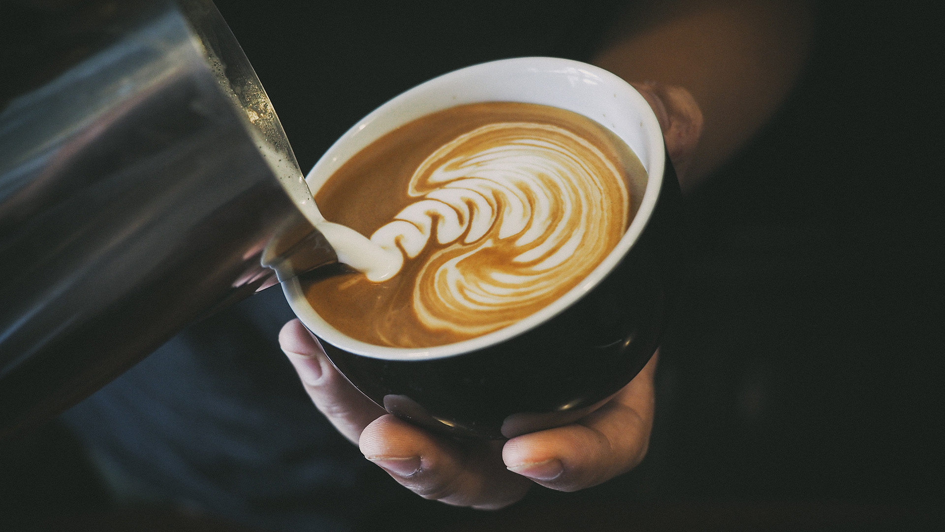Barista pouring latte art 