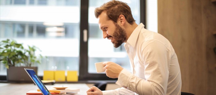 A woman in her house using a laptop for a virtual meeting