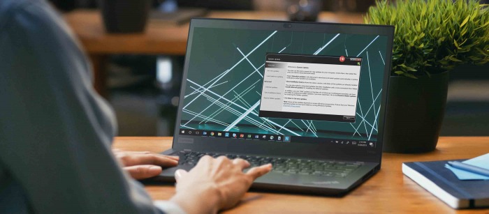 A woman in her house using a laptop for a virtual meeting