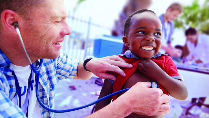 A seated young black girl in a pink and red tank top and red-accented headphones looks downward with a serious expression