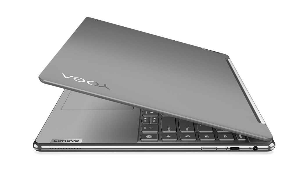 Vista frontal del lateral derecho del portátil 2-en-1 Yoga 9i de 8.ª generación en color Storm Grey, abierto en un ángulo de 45 grados, mostrando parte del teclado, la cubierta superior y los puertos del lateral derecho