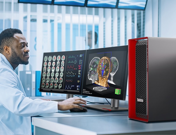 Healthcare professional looking at brain scans on a monitor, with a Lenovo ThinkStation P5 workstation to the right