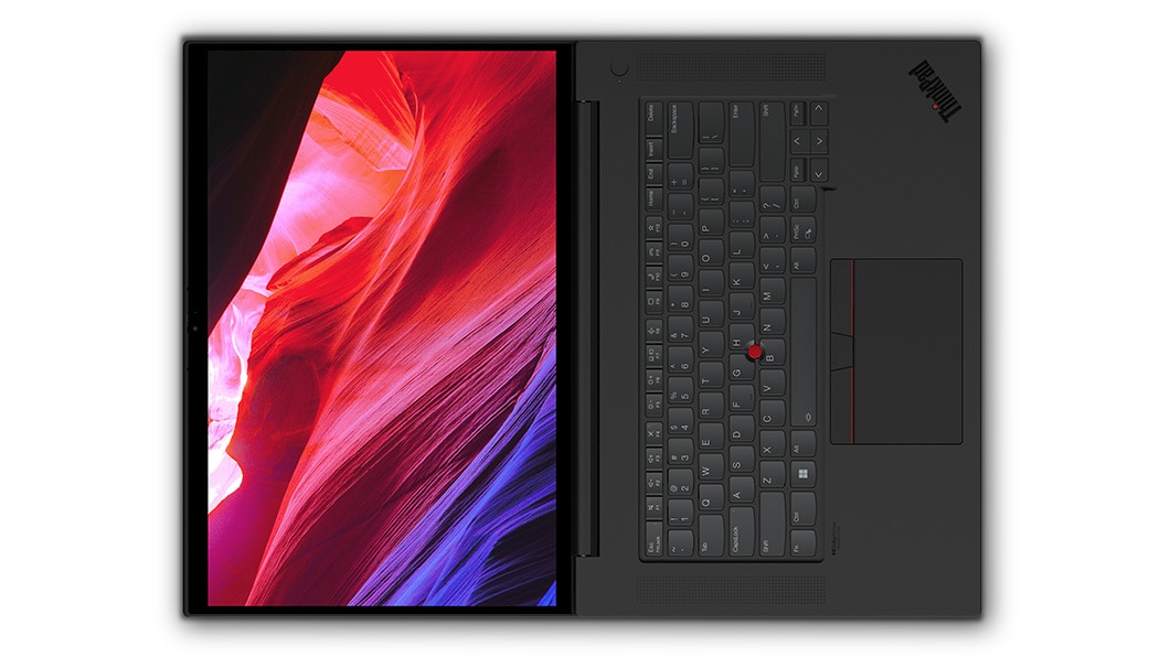 Aerial view of Lenovo ThinkPad P1 Gen 6 (16″ Intel) mobile workstation, opened flat 180 degrees, showing full keyboard & display with flowing red and blue shapes on screen