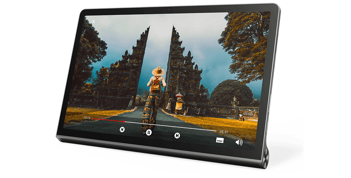 Lenovo Yoga Tab 11 tablet—front view, propped up, showing a video of person walking down a paved path toward some sort of stone ruins