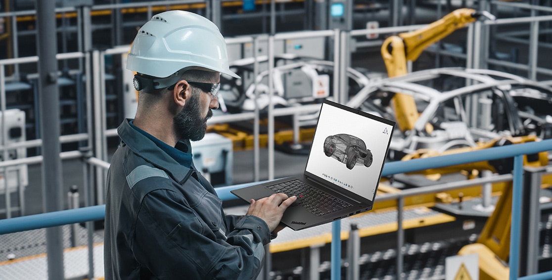Car engineer at work in a factory, looking at designs on a Lenovo ThinkPad P1 Gen 6 (16″ Intel) mobile workstation