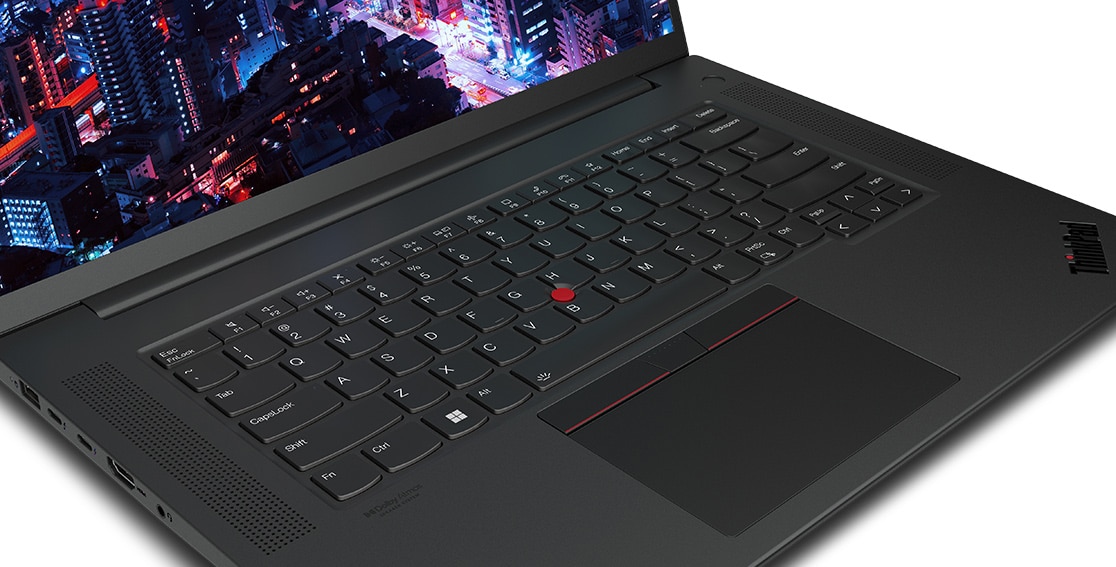 Close up of Lenovo ThinkPad P1 Gen 6 (16″ Intel) mobile workstation, opened at an angle, showing part of keyboard & part of display with a night skyscraper scene