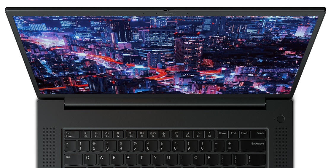 Close up of forward-facing Lenovo ThinkPad P1 Gen 6 (16″ Intel) mobile workstation, opened, showing part of keyboard & display with a night skyscraper scene