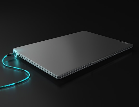 View of closed Lenovo IdeaPad Slim 5 with digitally enhanced power cable plugged into to simulate rapid charging.
