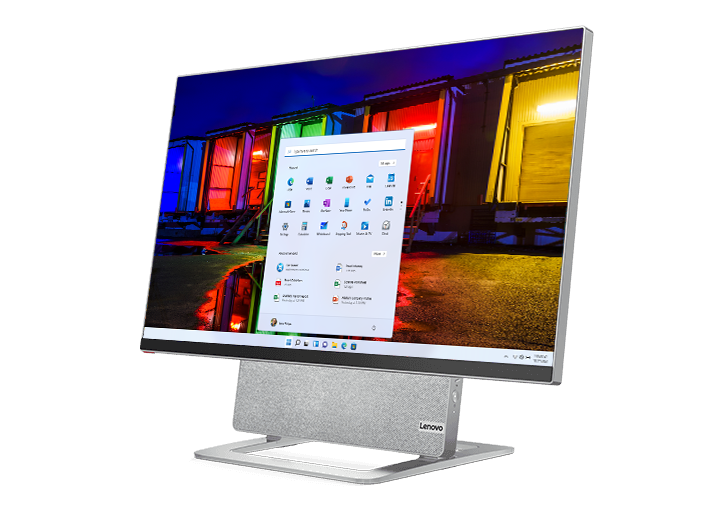 Yoga AIO 7 (27″ AMD) front view at left angle, screen on, picture of rocky seashore