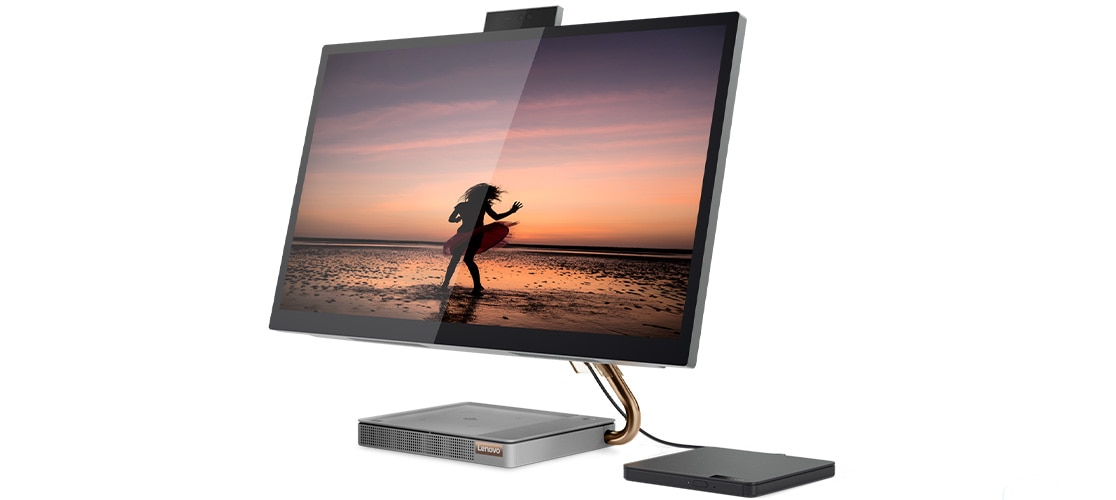 Side view of the IdeaCentre A540 (27), with an image of a woman on a beach, and back-up hard drive (sold separately)