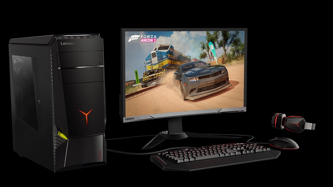 Lenovo Legion Y920 Tower, front left side view with gaming peripherals and racing game on monitor display.