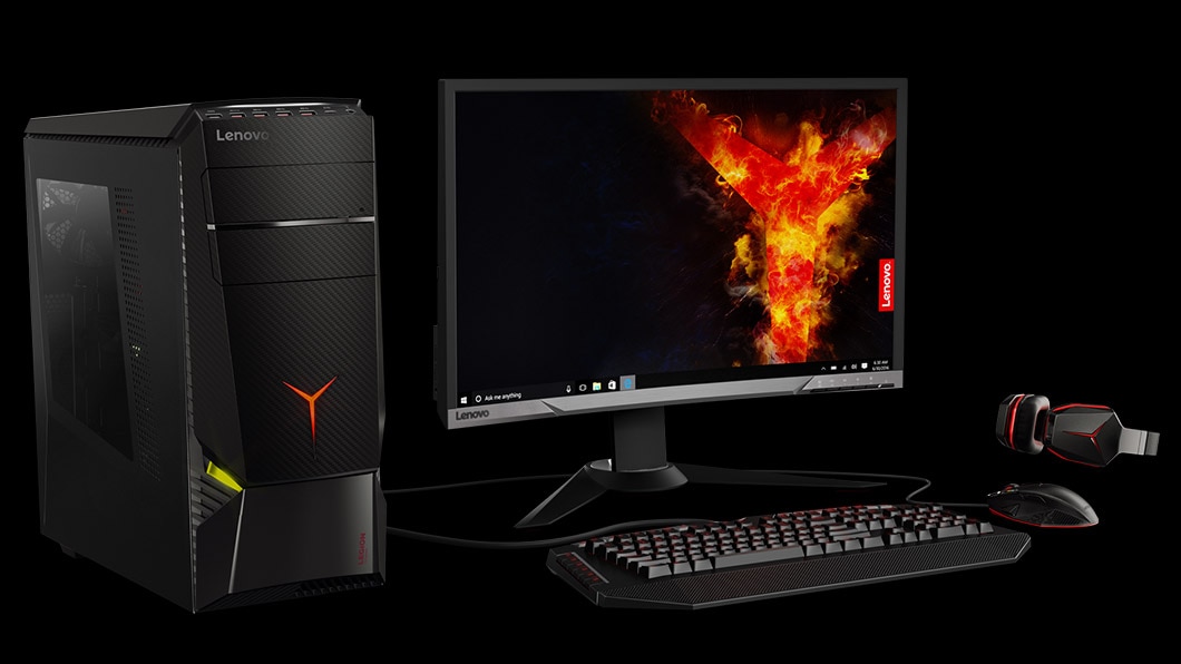 Lenovo Legion Y920 Tower, front left side view with gaming peripherals and Legion graphic on monitor display.