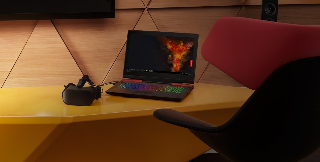 Lenovo Legion Y920 atop a desk and beside an Oculus Rift VR headset