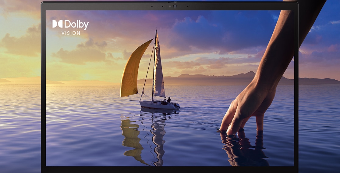 16in by Vision display on the Lenovo ThinkPad X1 Extreme Gen 4 laptop with a sailboat on clear blue ocean water and a life-sized hand reaching through, extending beyond the screen and onto the page.