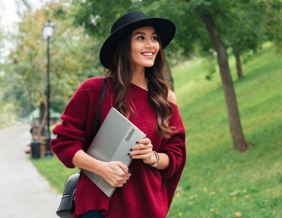 Woman carrying Lenovo ThinkBook 13s Gen 3 (13
