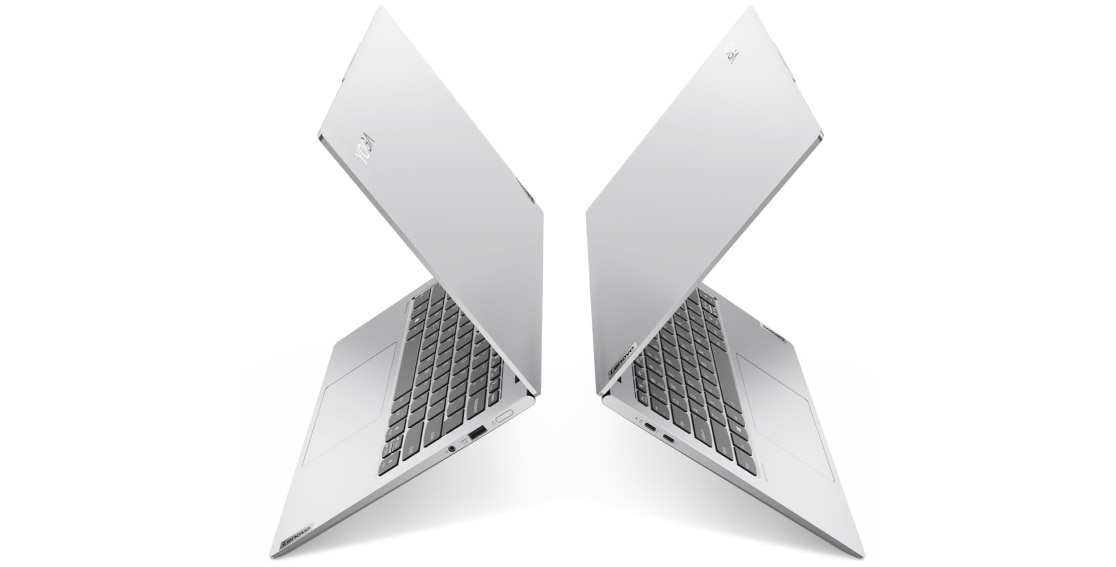 Two Lenovo Yoga Slim 7i Pro 14 silver laptops back to back,  left and right profile view