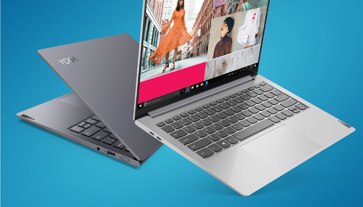2 Lenovo Yoga Slim laptops sitting back to back. One in dark gray and one in light silver.