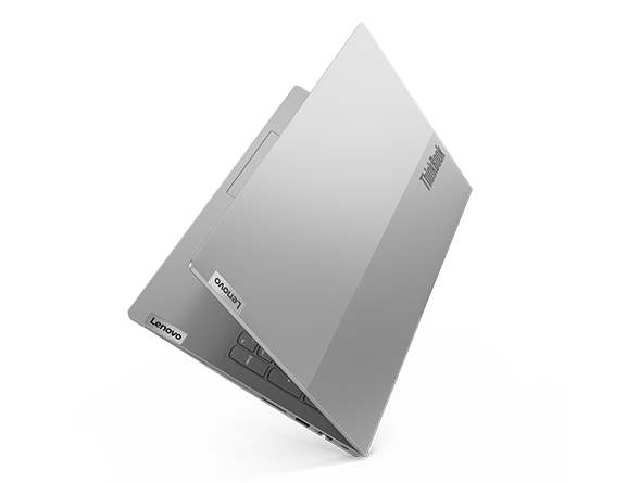 A Lenovo ThinkBook 15 laptop, open just 30 degrees and positioned as if standing on its right-rear corner, revealing the attractive, dual-tone top cover.