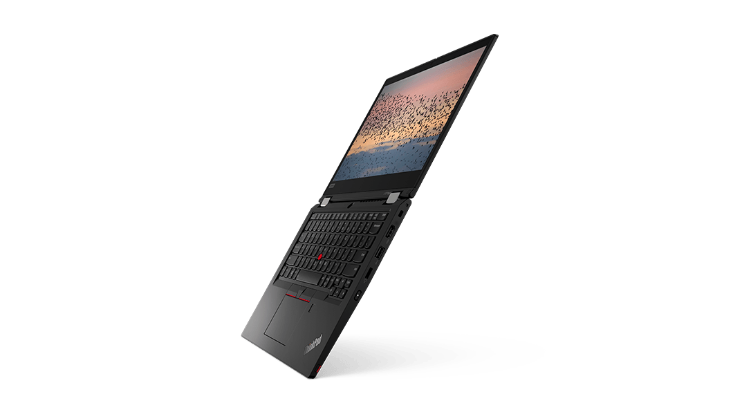 ThinkPad L13 Yoga di seconda generazione (13'' -AMD) aperto a 180 gradi, mostrato dal lato destro, con tastiera e display, con uno stormo di uccelli che attraversa il cielo al tramonto