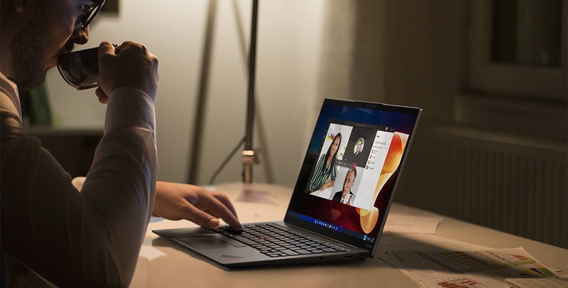 Person at a table videoconferencing on the Lenovo ThinkPad X1 Carbon Gen 10 laptop.
