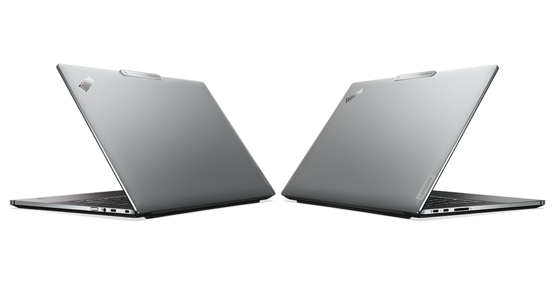 Two Lenovo ThinkPad Z16 laptops, back-to-back, angled to show recycled aluminum covers and ports on both sides.