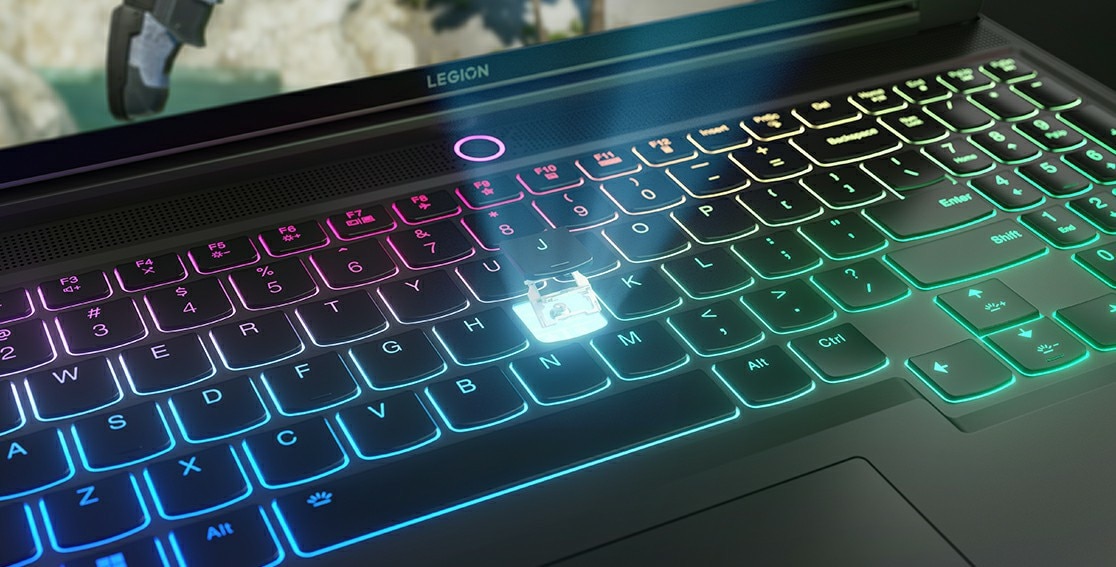 The multicolor illuminated keyboard of the Lenovo Legion Slim 7i Gen 8 (16 Intel), with a breakaway view of the “J” key showing components