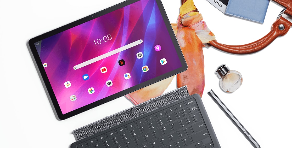 Lenovo Tab P11 Plus tablet—front view with home screen and multiple app icons on the display, plus optional keyboard and pen, all on top of handbag and scarf, with several personal items strewn about