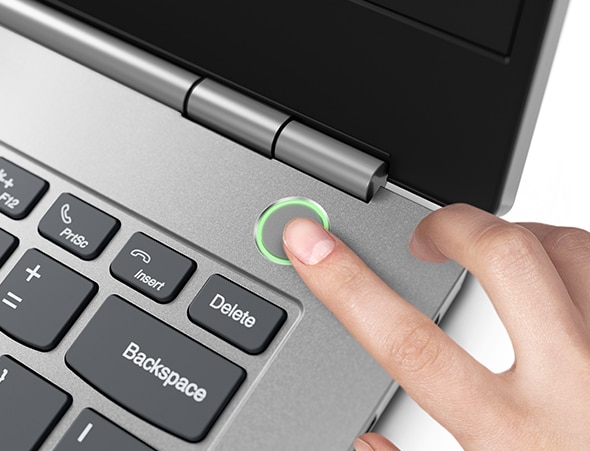 A close-up of someone pressing the touch fingerprint reader on the power button