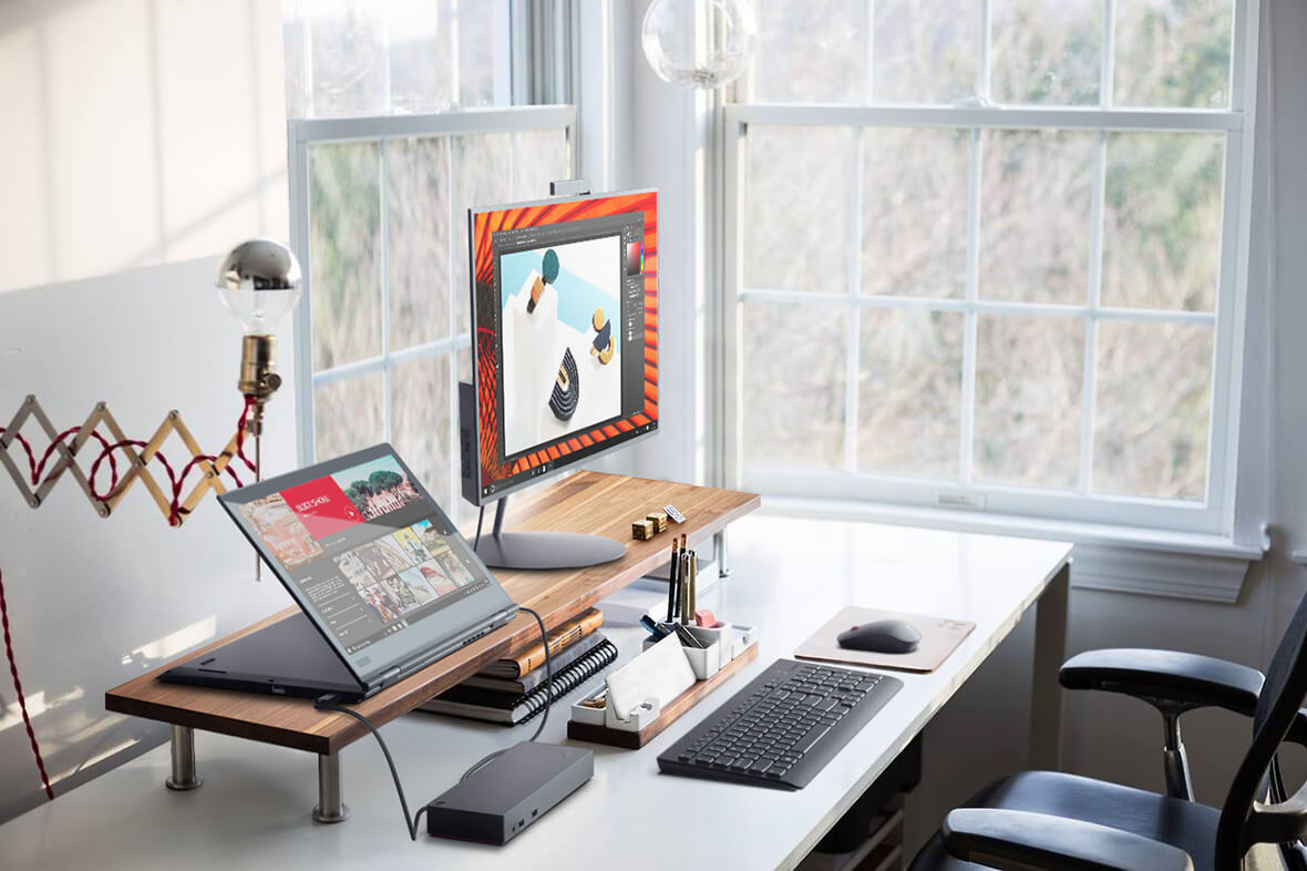 Lenovo ThinkPad X1 Yoga laptop on desktop, with Thunderbolt port connected to monitor.