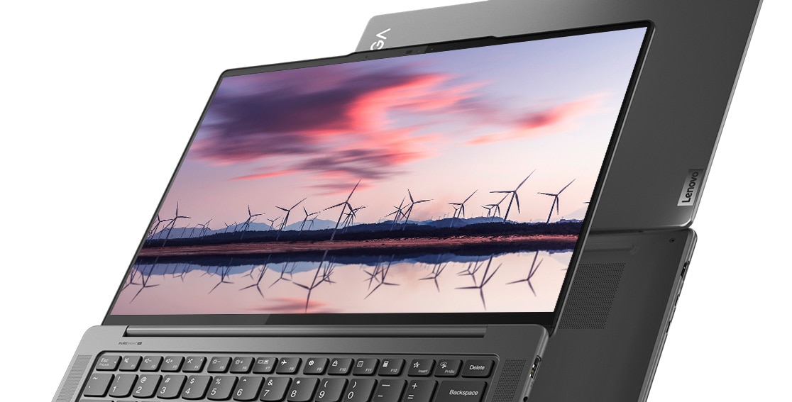 The Lenovo Yoga Pro 7i Gen 8 (14” Intel) 2-in-1 laptop in tent mode with an image of a windmill farm reflected in water on the display